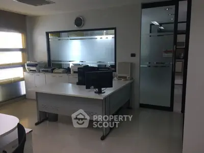 Modern office space with sleek furniture and frosted glass partitions