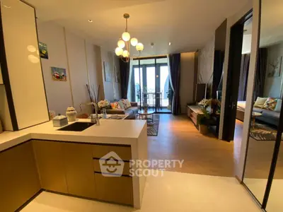 Modern open-layout living room with stylish kitchen and balcony view