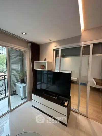 Modern living room with sleek TV stand and balcony view