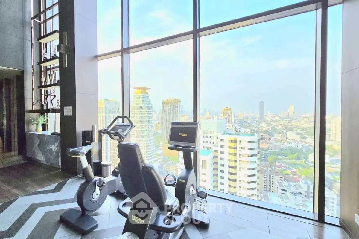 Luxurious high-rise gym with panoramic city views and modern fitness equipment.