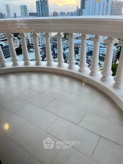 Luxurious balcony with stunning cityscape view, perfect for relaxation and enjoying urban living.