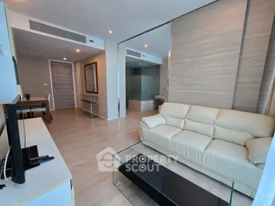 Modern living room with sleek furniture and glass coffee table in a stylish apartment.