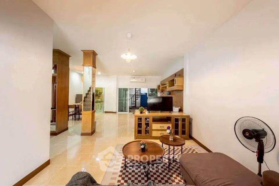 Spacious living room with modern decor and open layout, perfect for family gatherings.