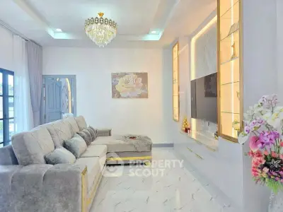 Luxurious living room with elegant chandelier and plush gray sofa