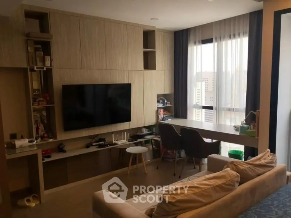 Modern living room with built-in TV unit and city view, perfect for urban living.