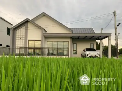 Modern single-story house with carport and lush green lawn