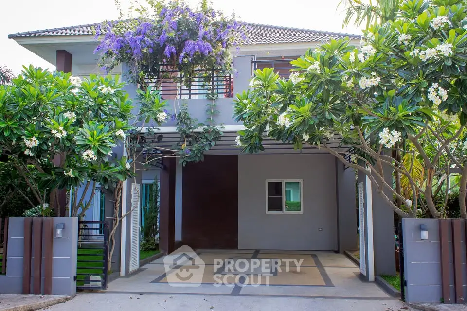 Charming two-story house with lush garden and modern facade