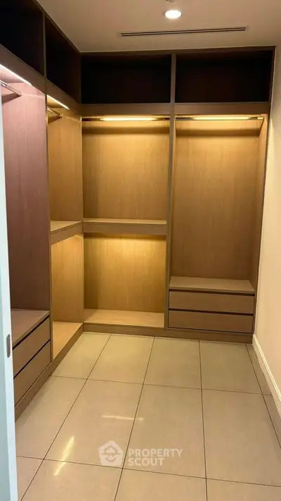Spacious walk-in closet with modern wooden shelving and ample storage space.