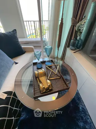 Stylish living room with modern decor and glass coffee table