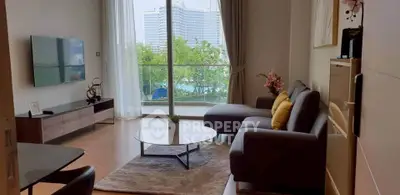 Modern living room with large window and stylish furniture overlooking city view.