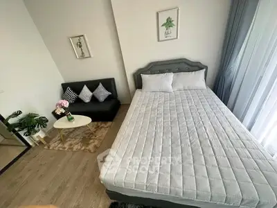 Modern bedroom with stylish decor and cozy seating area, perfect for relaxation.