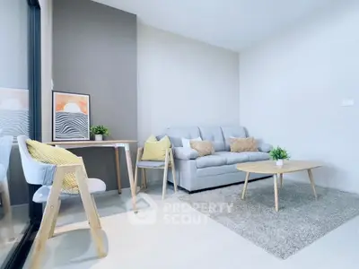 Modern living room with cozy sofa, stylish chairs, and elegant decor in a bright, inviting space.