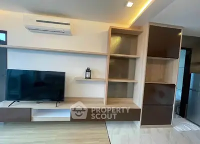 Modern living room with sleek TV unit and air conditioning, featuring stylish shelving and contemporary design.