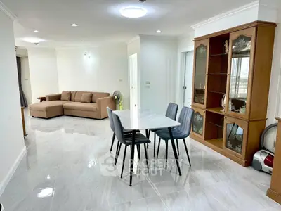 Spacious living and dining area with modern furniture and elegant flooring