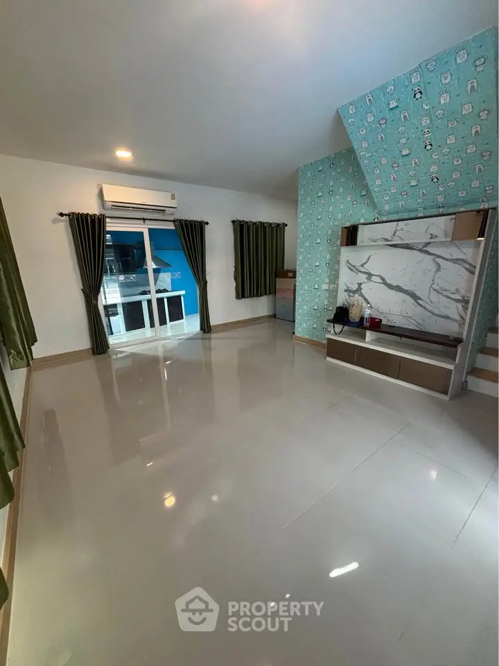 Spacious living room with modern decor and large windows for natural light.