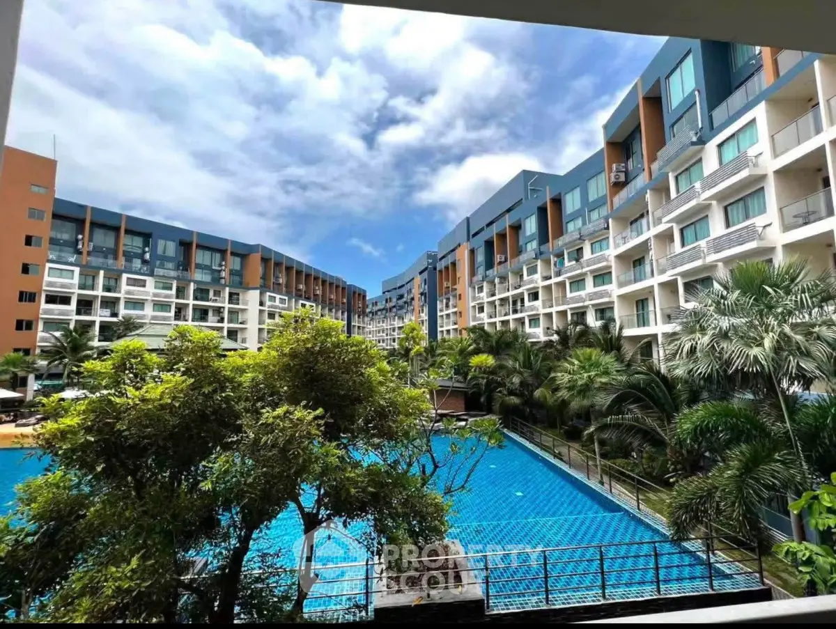 Luxurious apartment complex with stunning pool and lush greenery