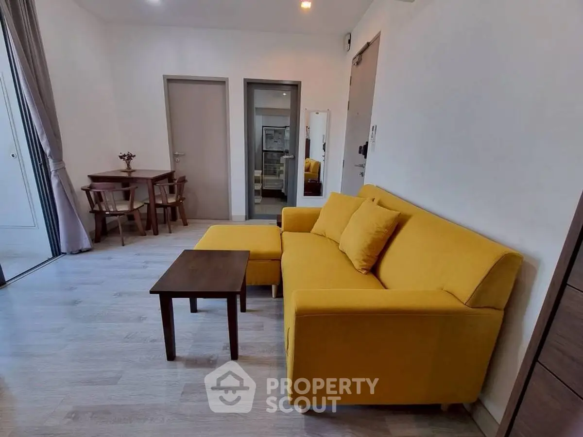 Modern living room with vibrant yellow sofa and stylish wooden furniture.