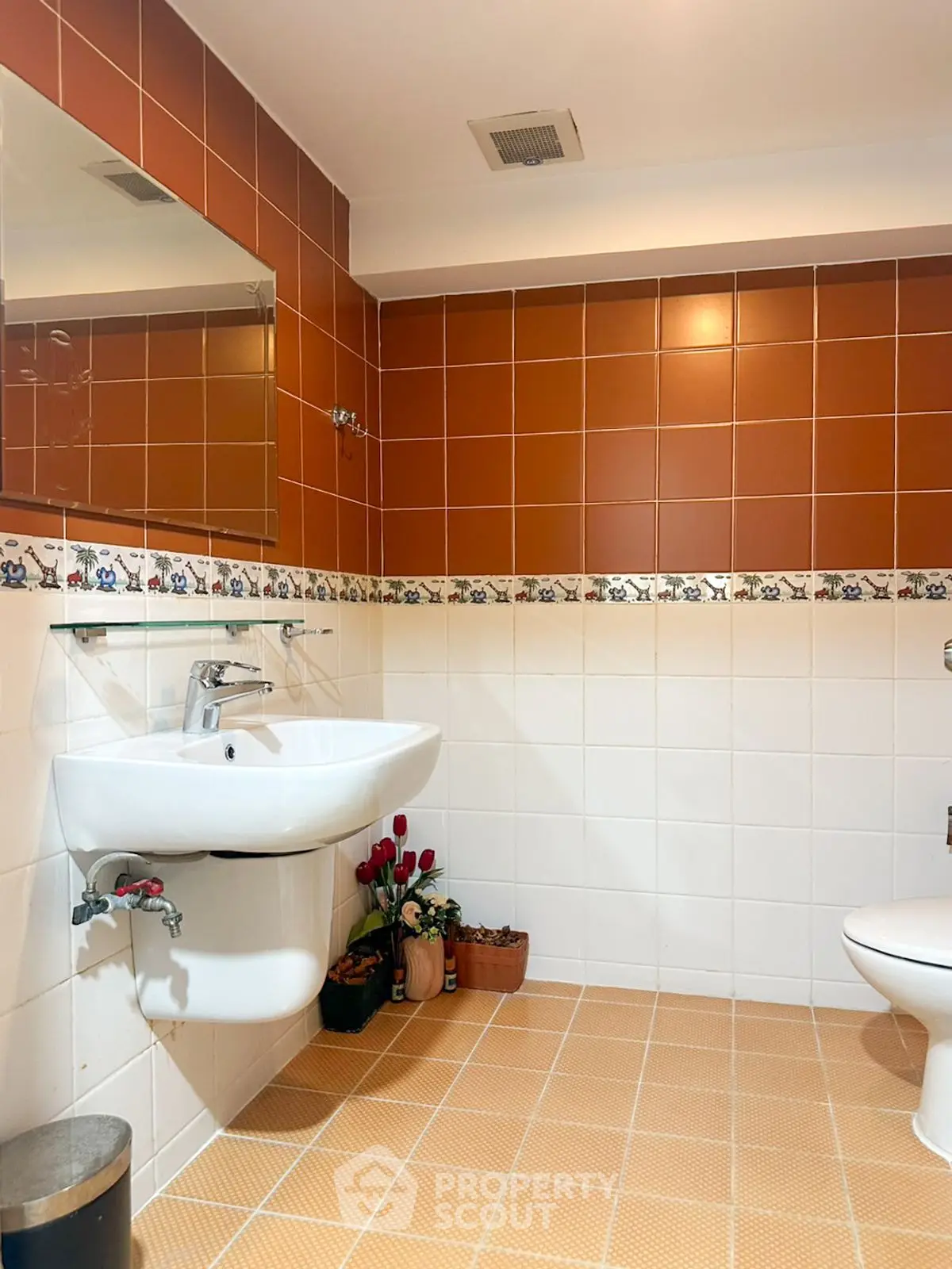 Charming bathroom with warm tiles and modern fixtures, perfect for a cozy home.