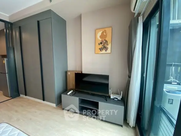 Modern living room with sleek furniture and large windows for natural light.