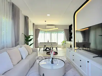 Luxurious modern living room with elegant decor and large TV