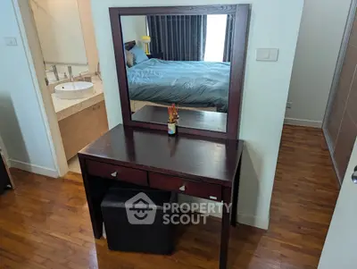 Elegant bedroom with wooden vanity and modern decor