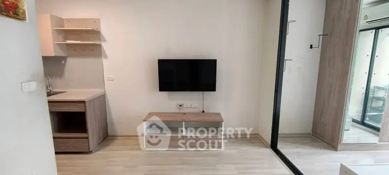 Modern living room with wall-mounted TV and sleek wooden furniture