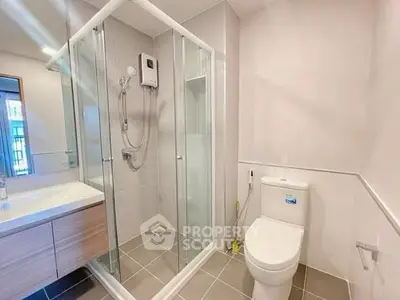 Modern bathroom with glass shower enclosure and sleek fixtures
