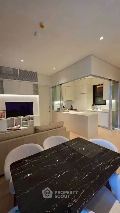 Modern open-plan living room with sleek kitchen and elegant dining area