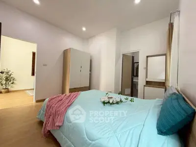 Spacious bedroom with modern decor and ample natural light
