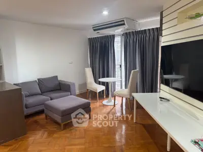 Spacious living room with modern furniture and natural light, perfect for relaxation and entertainment.