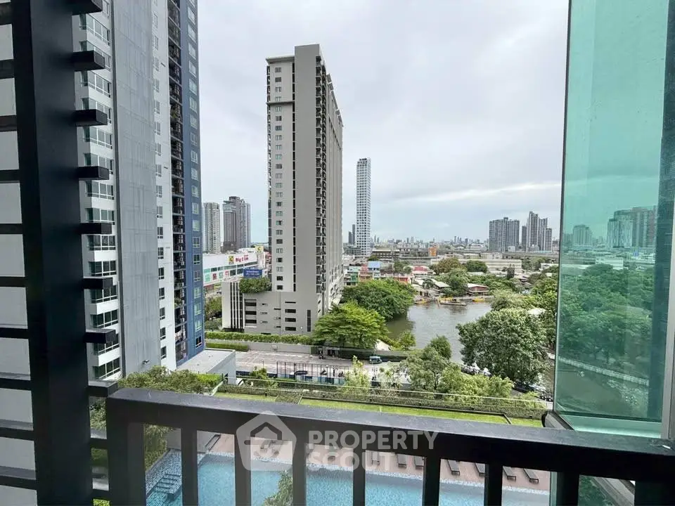 Stunning urban view from a high-rise balcony overlooking cityscape and river, perfect for modern living.