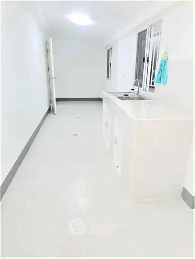 Spacious utility room with modern sink and bright lighting