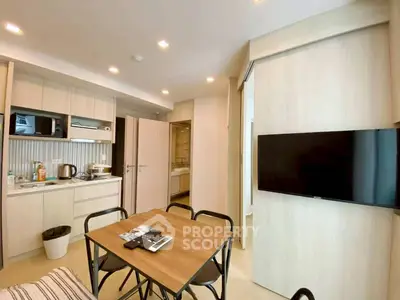 Modern open-layout kitchen and dining area with sleek appliances and stylish decor.