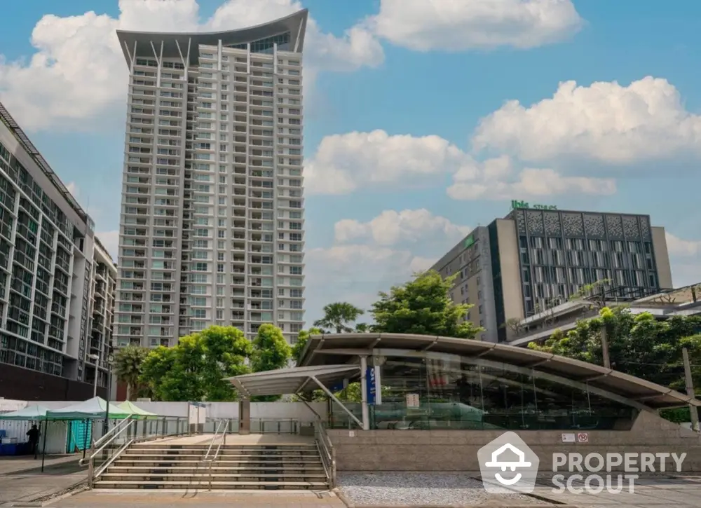 Modern high-rise building with unique architectural design and lush surroundings