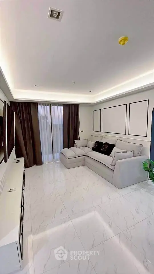 Spacious modern living room with elegant decor and large windows