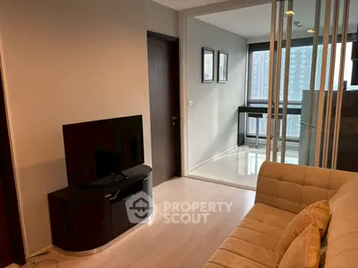Modern living room with sleek TV stand and cozy sofa, featuring a mirrored wall and city view.