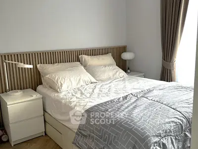 Modern bedroom with stylish decor and cozy ambiance, featuring elegant bedding and natural light.