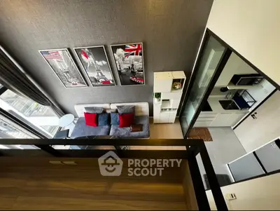 Modern loft apartment with stylish decor and open layout, featuring a cozy living area and sleek kitchen.