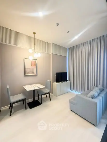 Modern living room with elegant decor, featuring a cozy sofa, dining table, and stylish lighting.