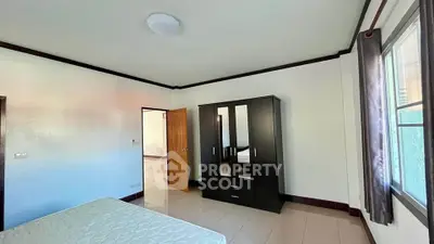 Spacious bedroom with natural light and modern wardrobe