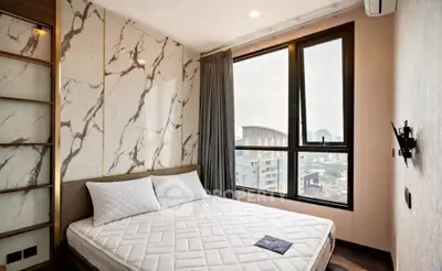 Modern bedroom with marble accent wall and city view