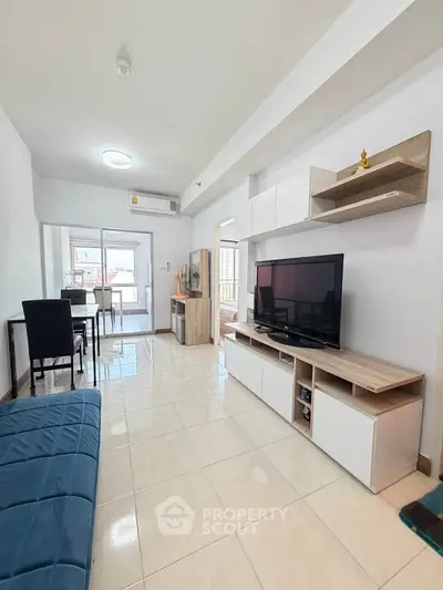 Modern living room with sleek furniture and natural light, perfect for urban living.
