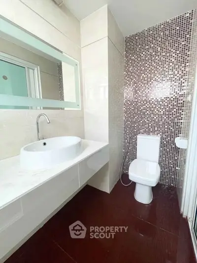 Modern bathroom with stylish mosaic tiles and sleek fixtures