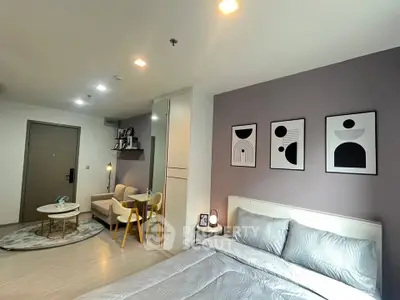 Modern bedroom with stylish decor and cozy seating area in a contemporary apartment.
