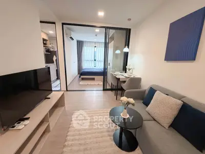 Modern open-plan living room with cozy seating and stylish decor in a contemporary apartment.