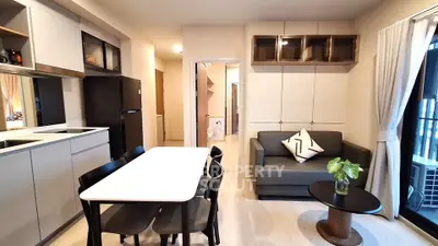 Modern open-plan living room and kitchen with sleek furniture and stylish decor