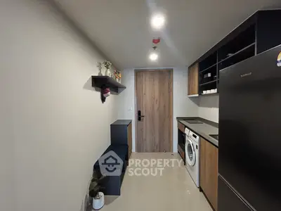 Modern kitchen with sleek black appliances and minimalist design