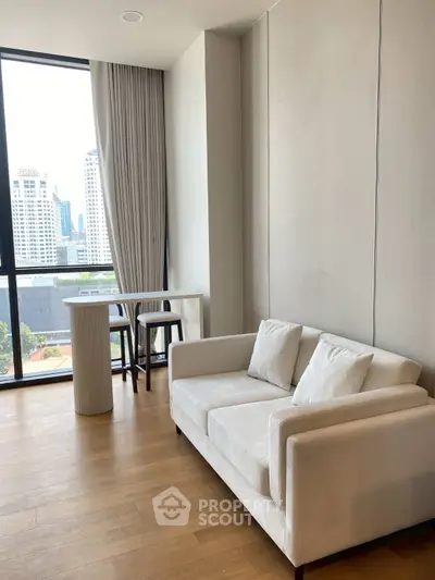 Modern living room with city view, featuring elegant white sofa and stylish dining area.