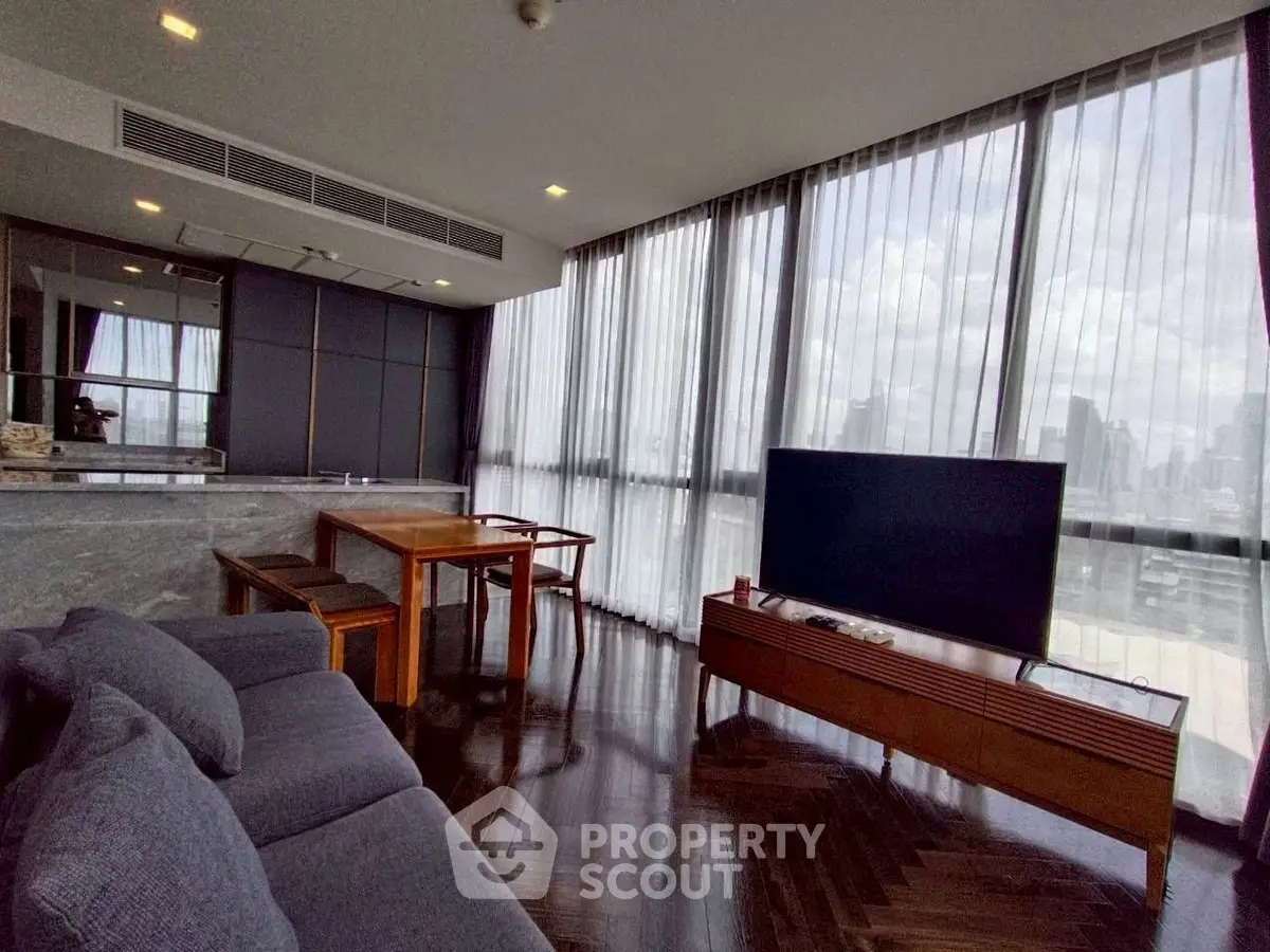 Luxurious modern living room with panoramic city views and elegant furnishings.
