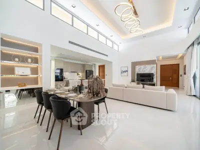 Luxurious open-plan living and dining area with modern decor and high ceilings